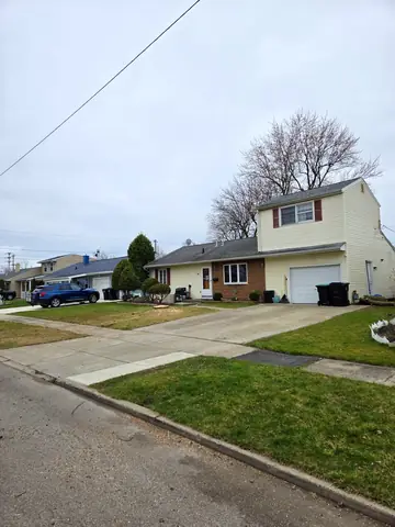 After the removal: the front yard clean and the driveway clear.