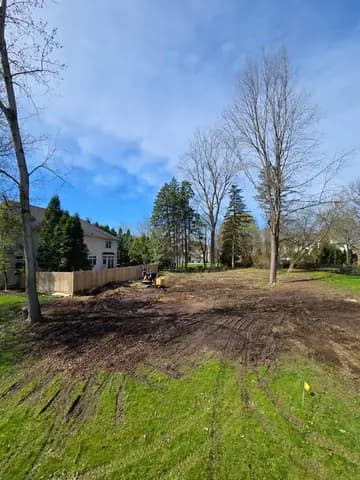 A backyard cleared of brush and small trees, ready to grade.